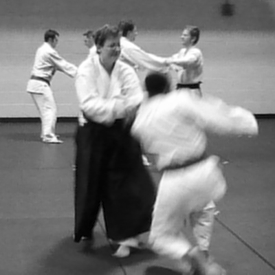 Aikido woman black belt performing aligned technique